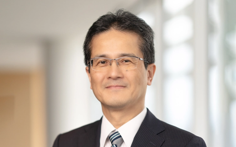 Portrait of Teiji Hirata (suit, tie and NISSAN corporate pin) (smiling)