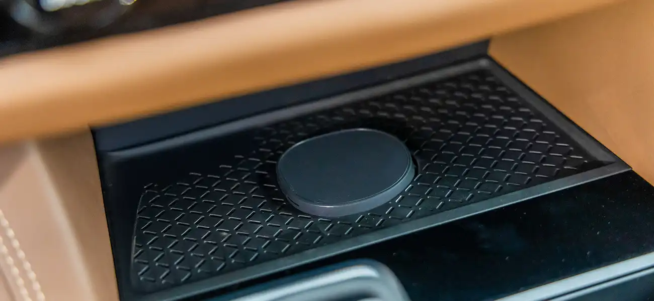 The New Nissan Qi2 wireless charger, it sits below the center dashboard controls.
