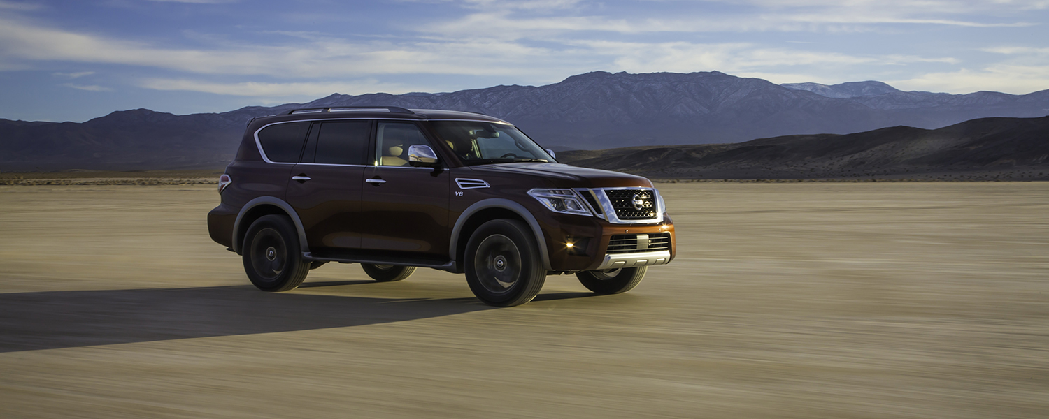 2017 Nissan Armada driving across a large flat dirt surface
