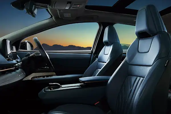 An image of the Nissan Ariya interior with a sunset in the background.