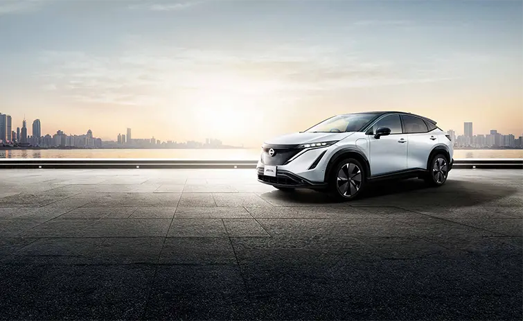 silver nissan parked along a sunset skyline