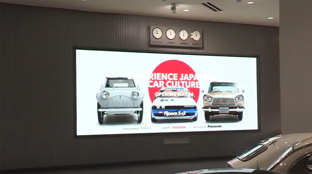An image of a screen from an exhibit that shows 3 cars.