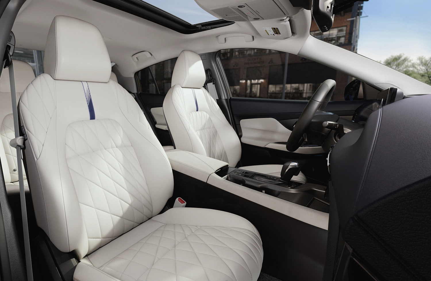 Wide angle of the driver and passenger seat of the Nissan Sentra.