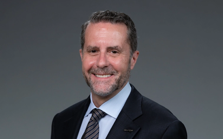 Portrait of Andrew House (suit, tie and NISSAN corporate pin)