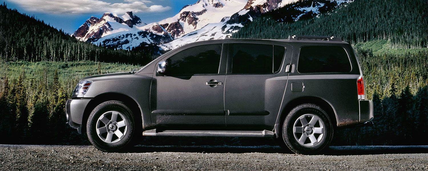 A grey Nissan Armada parked in a mountain setting