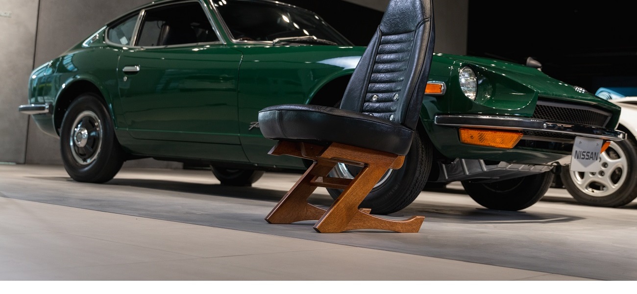 An image of a green Nissan car and a black Nissan Z chair.