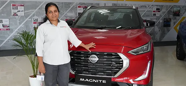 Tamil Nadu standing in front of a Nissan