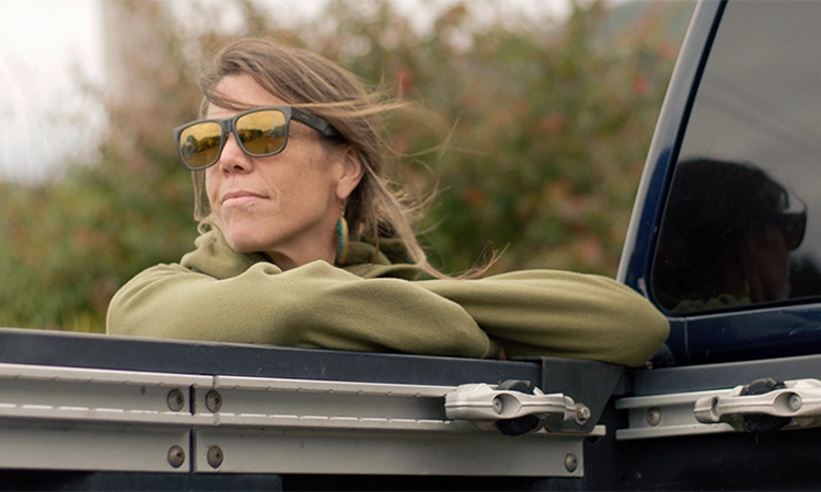 Jamie Schou leaning on the trunk of her Titan.