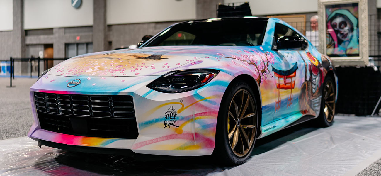 Nissan Z pained with multiple colors such as light blue, red, purple, yellow, and red.