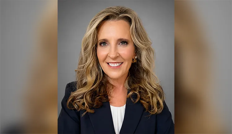 Headshot of Ashley Gatlin smiling against grey background