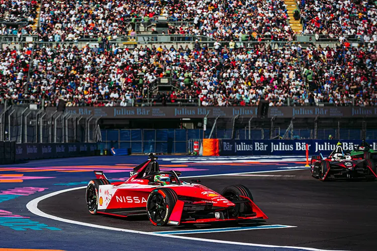 Red race car turning corner on track