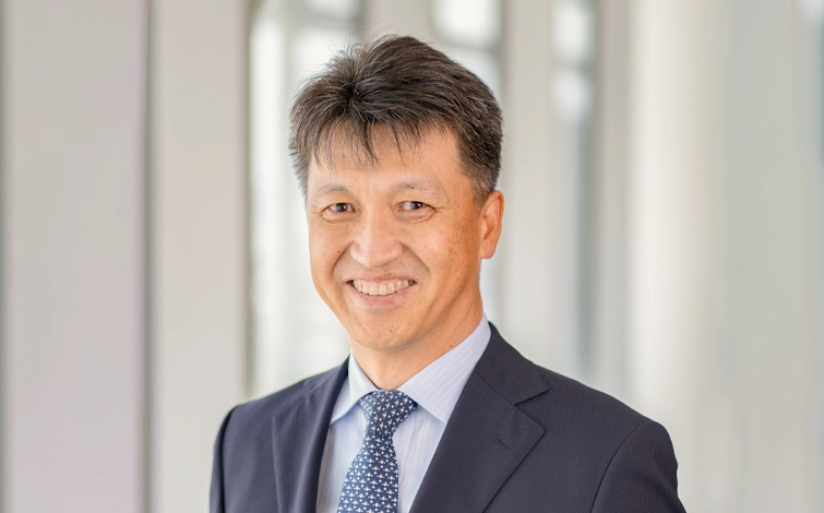 Portrait of Manabu Sakane (suit, tie and NISSAN corporate pin) (smiling)