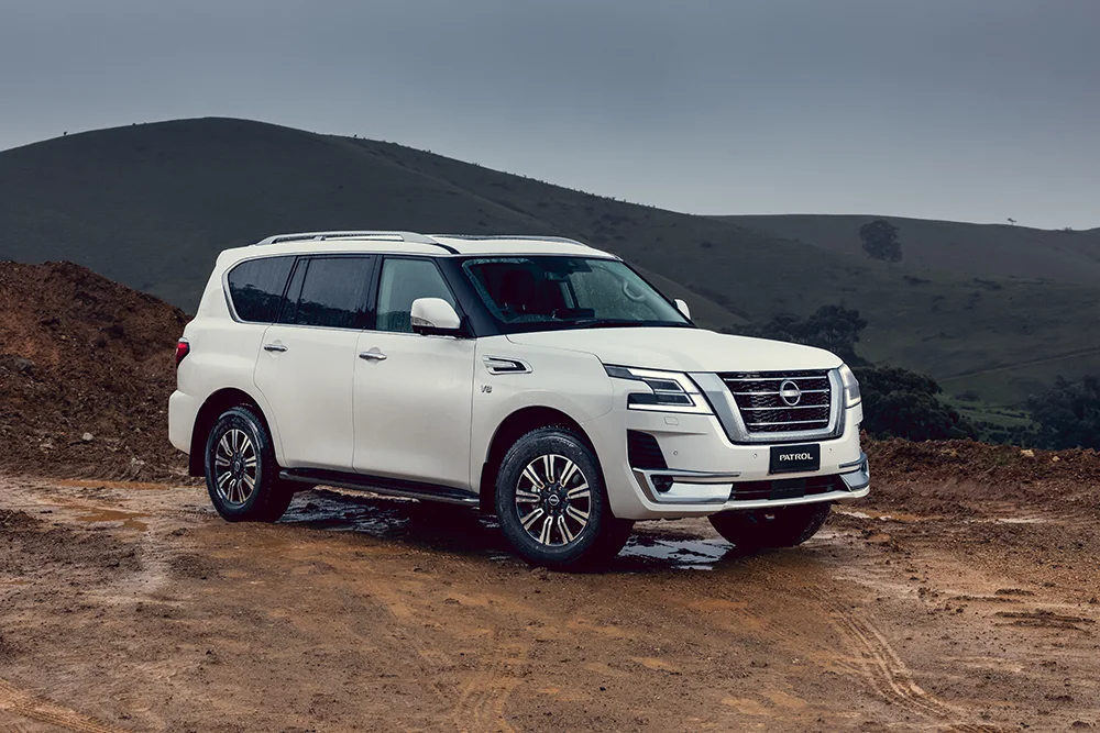 Front three-quarter exterior landscape view of a Moonstone White 2026 Nissan Y62 Patrol Ti-L
