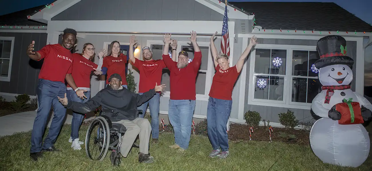 a group of people standing in front of a house